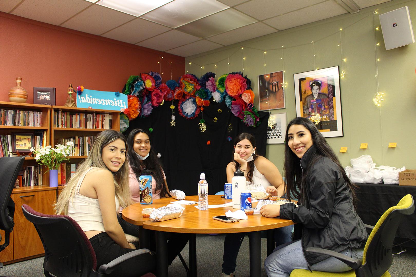 Four students enjoy their lunch while at the welcome celebration